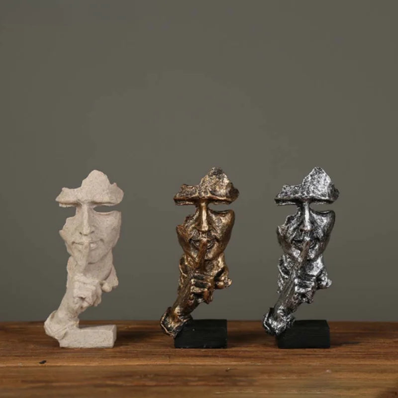 Estatueta abstrata "O Silêncio é Ouro" de resina.