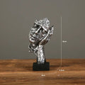 Estatueta abstrata "O Silêncio é Ouro" de resina.