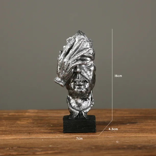 Estatueta abstrata "O Silêncio é Ouro" de resina.